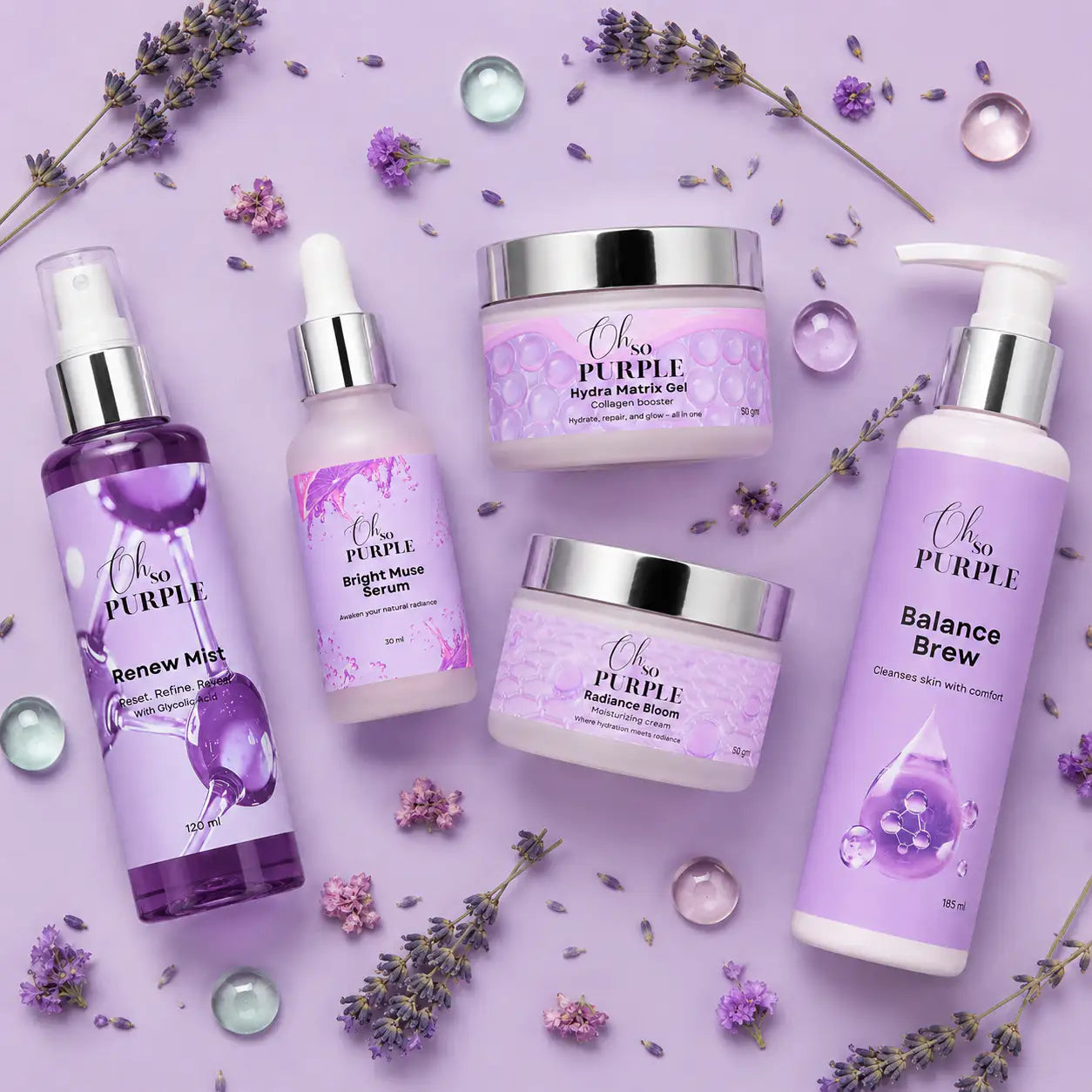 Five beauty products from Oh so Purple arranged on a lavender background with scattered lavender sprigs and clear decorative stones. The products include Renew Mist, Bright Juice Serum, Hydro Balance Gel, Hydrating Mask, and Balance Brew.